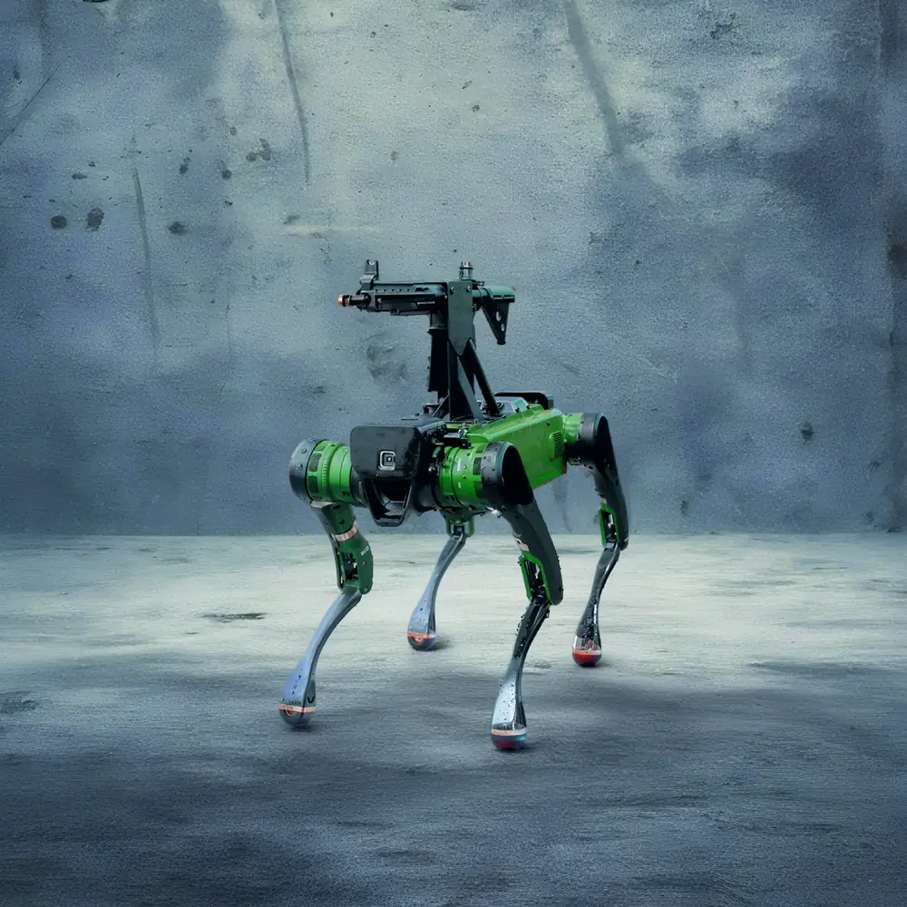Prahasta, a four-legged Zen robot carrying a mounted weapon station, standing on concrete.